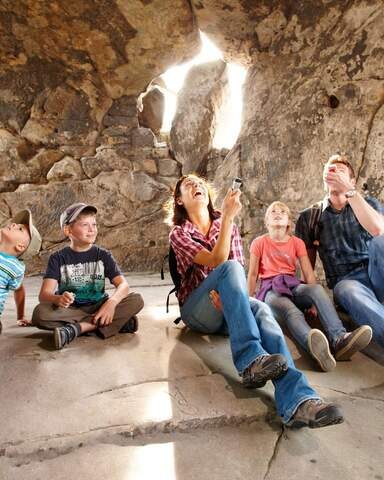 familie in höhle taschenlampe